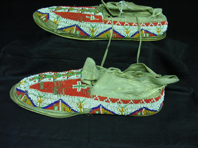 Appraisal: NATIVE AMERICAN BEADED MOCCASINS All over bead work upper on