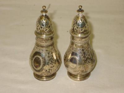 Appraisal: A PAIR OF VICTORIAN PEPPERS of pear form with disc