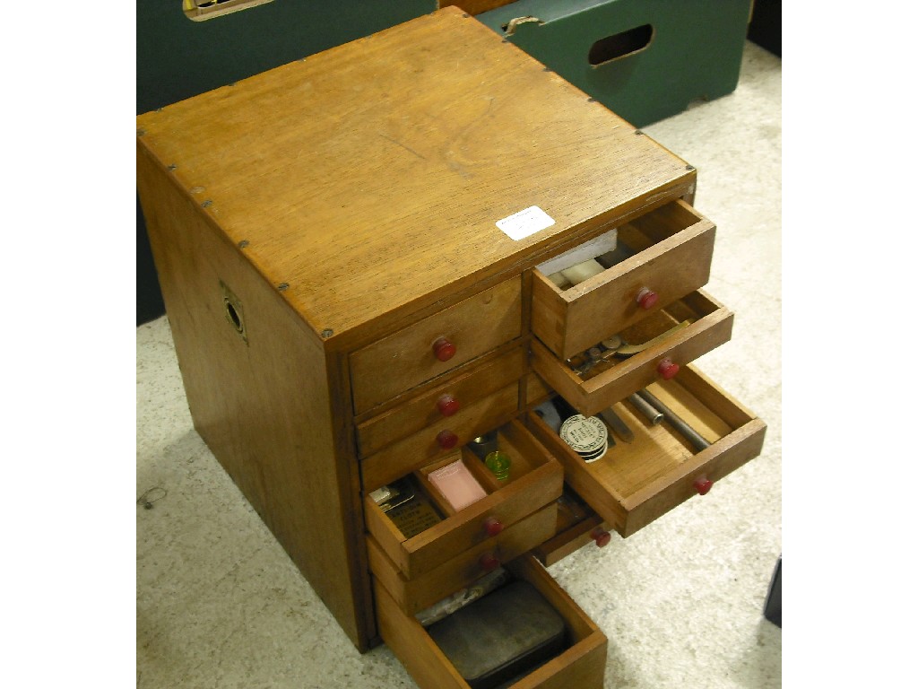 Appraisal: Oak watchmaker's small travelling chest of sixteen drawers fitted with