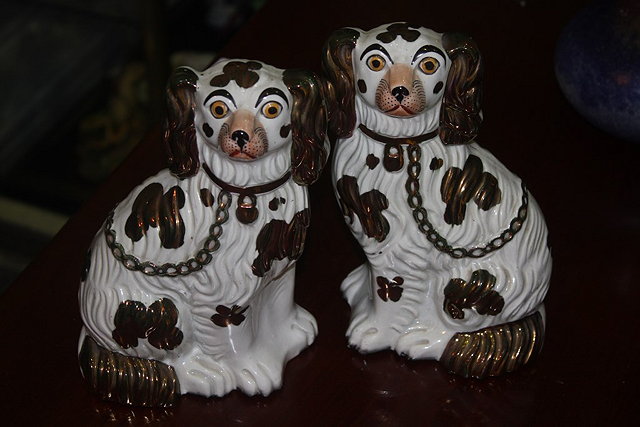 Appraisal: A PAIR OF VICTORIAN COPPER LUSTRE POTTERY SPANIELS cm