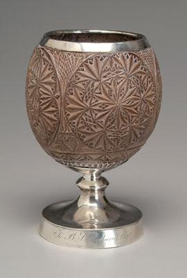 Appraisal: Georgian silver-mounted carved coconut Circular geometric forms silver mount rim