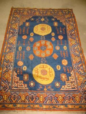 Appraisal: AN EAST TURKISTAN RUG the deep blue field with orange