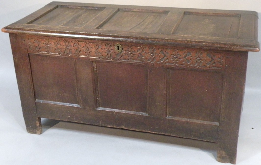 Appraisal: An thC oak three panelled coffer the plain carved lid