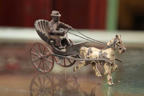 Appraisal: CAST IRON TOY A white horse pulling a lone man