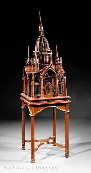 Appraisal: A Large Carved Hardwood Cathedral-Form Birdcage on Stand domed spindled