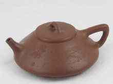 Appraisal: A Chinese dark brown Yixing style teapot with incised decoration