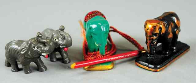 Appraisal: FOUR ELEPHANTS FIGURAL PAPERWEIGHTS Includes green painted example with attached