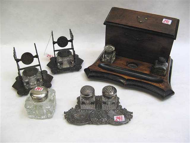 Appraisal: COLLECTION OF FIVE INKWELLS a wood desk set having hinged