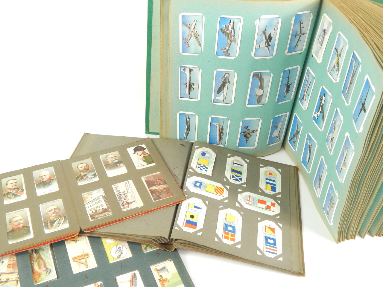 Appraisal: Four albums of Wills Players and Ogdens Cigarette cards including