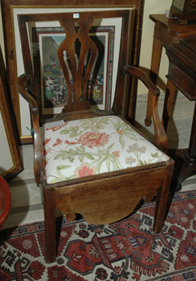 Appraisal: A GEORGE III WALNUT ARMCHAIR The straight crest rail above