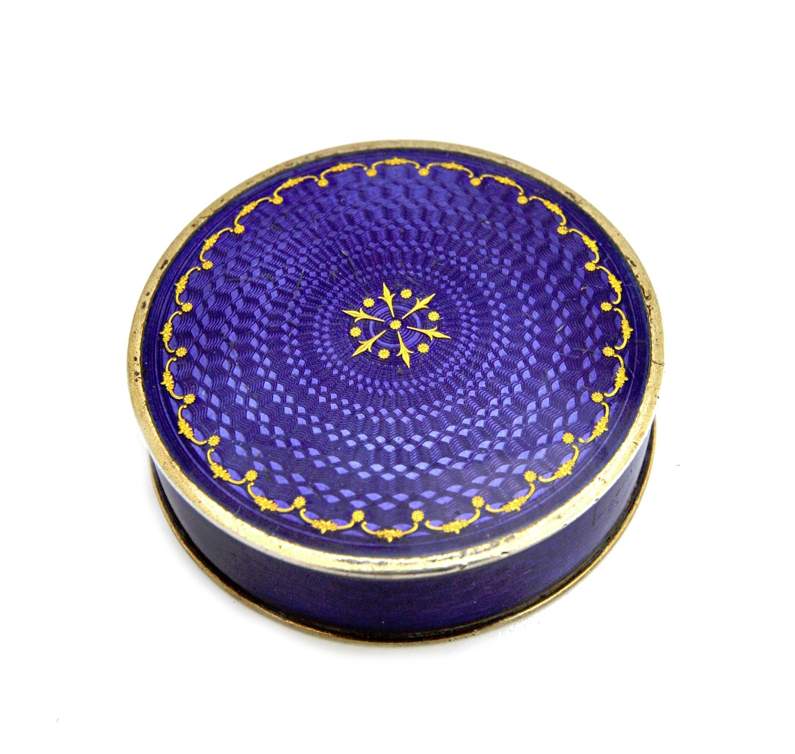 Appraisal: A silver and translucent purple enamelled circular box with a