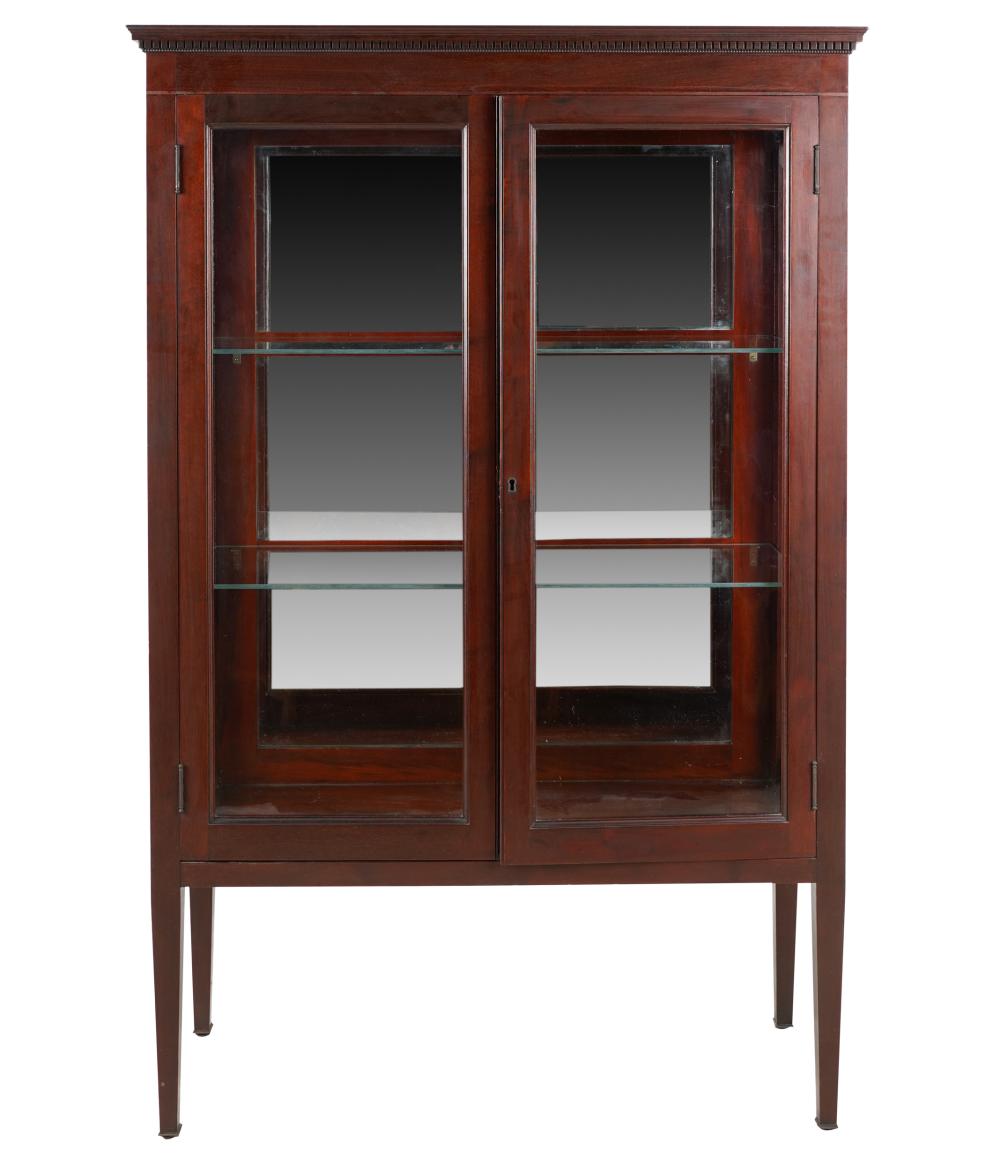 Appraisal: GLAZED MAHOGANY BOOKCASEwith dentil molding over two hinged doors flanked