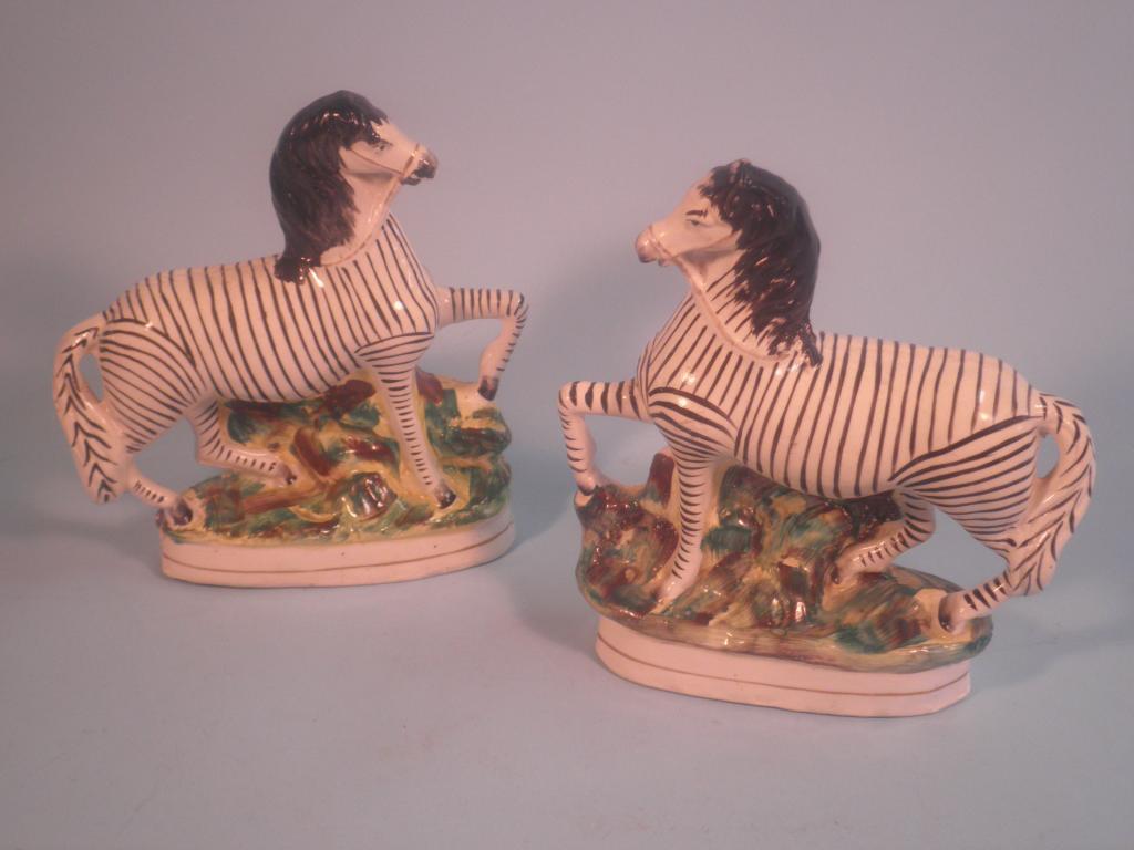 Appraisal: A pair of thC Staffordshire pottery flatback figures of zebra