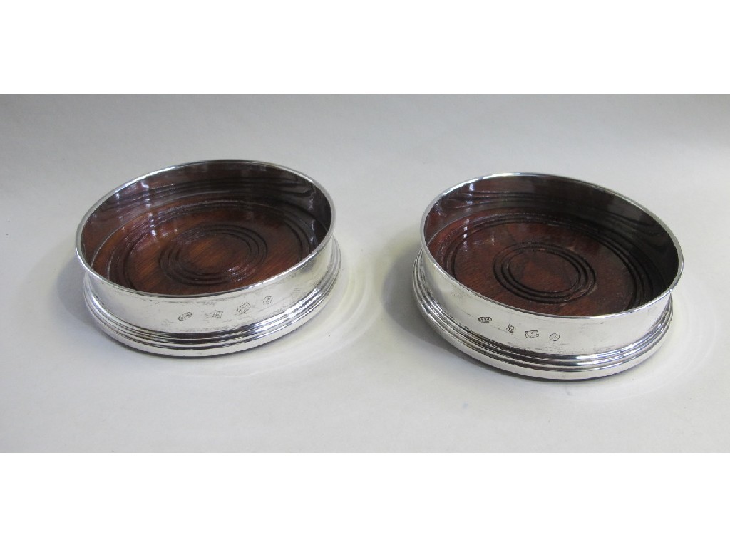 Appraisal: Pair of modern silver wine coasters Birmingham