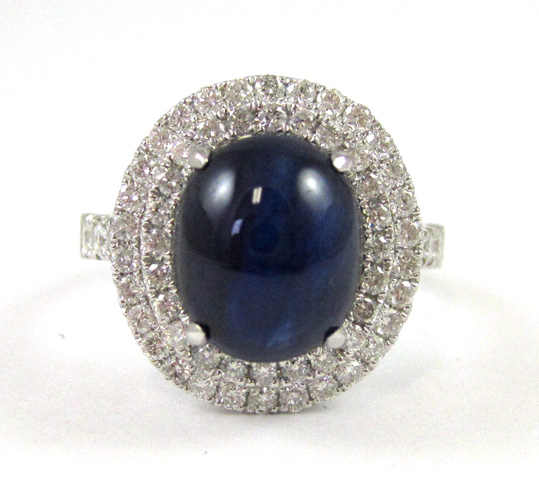 Appraisal: SAPPHIRE AND FOURTEEN KARAT WHITE GOLD RING with round-cut diamonds