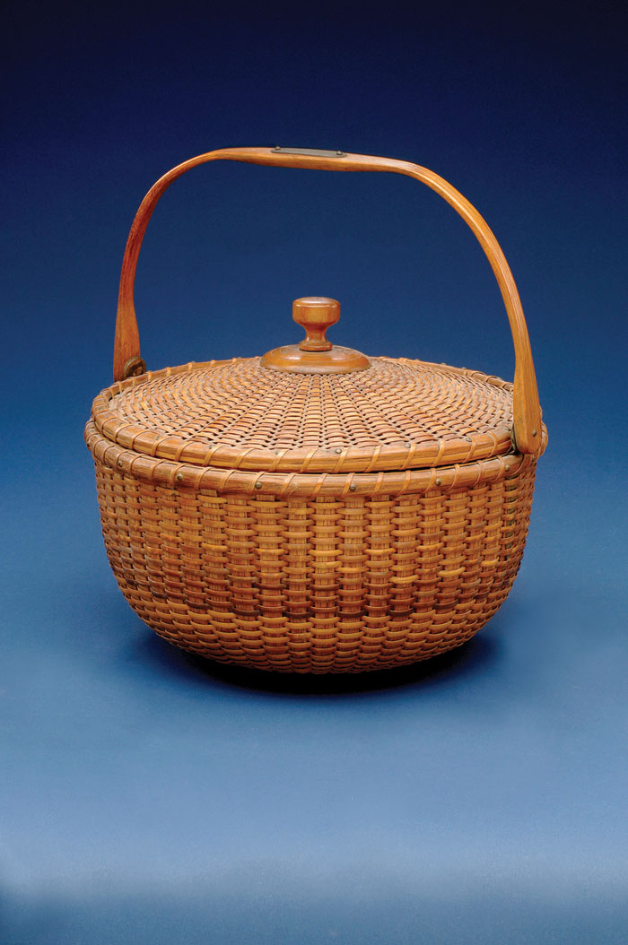 Appraisal: COVERED NANTUCKET BASKET WITH HINGED LID IN THE MANNER OF