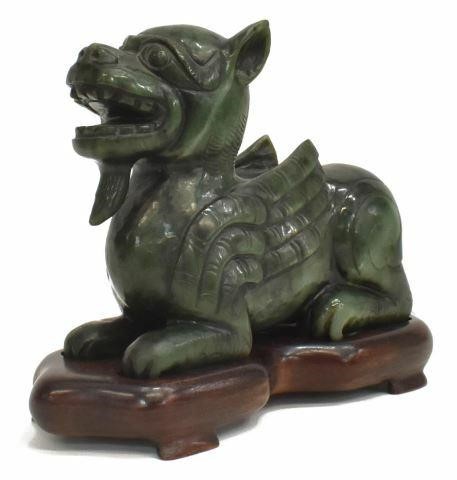 Appraisal: Chinese carved spinach green hardstone dragon chilong on hardwood stand