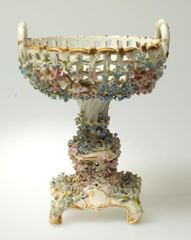 Appraisal: CONTINENTAL PORCELAIN COMPORT late th century the twin-handled open basketwork