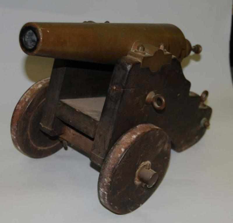 Appraisal: Brass Cannon Description With wooden front wheels Condition Excellent Size