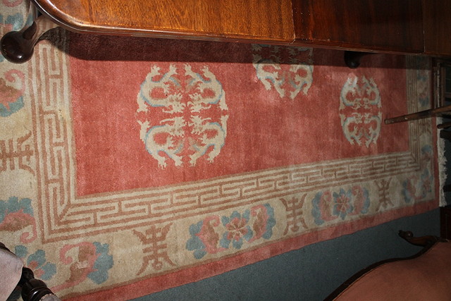 Appraisal: A CHINESE SALMON PINK GROUND LARGE RUG with three dragon