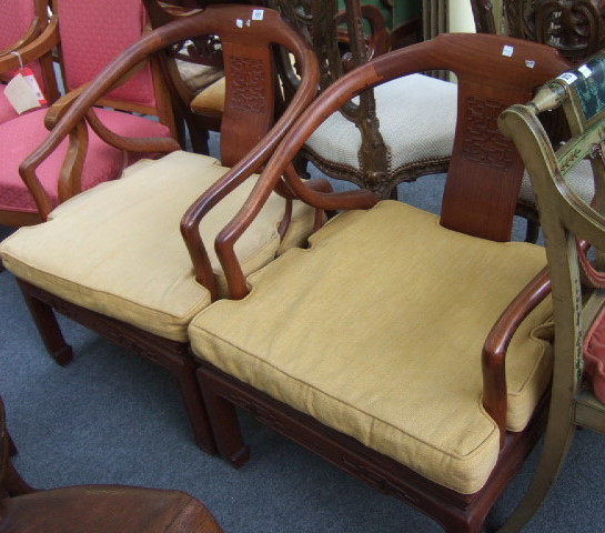 Appraisal: A pair of th century Chinese hardwood Yoke back chairs