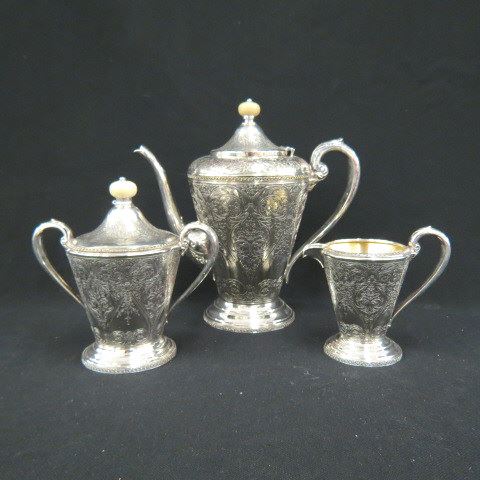 Appraisal: Silverplate Coffee Service elaborate engraving overall with ivory finials pot