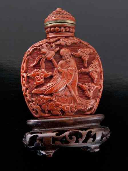 Appraisal: Chinese Qing Qianlong carved cinnabar snuff bottledepicting two immortals Four