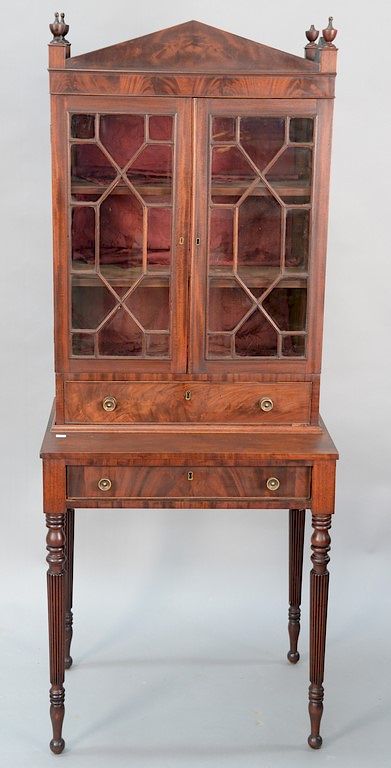 Appraisal: Sheraton mahogany two part cabinet on fluted legs circa height