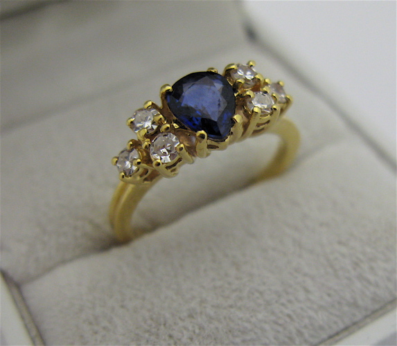 Appraisal: SAPPHIRE DIAMOND AND KARAT GOLD RING centering a pear-cut blue