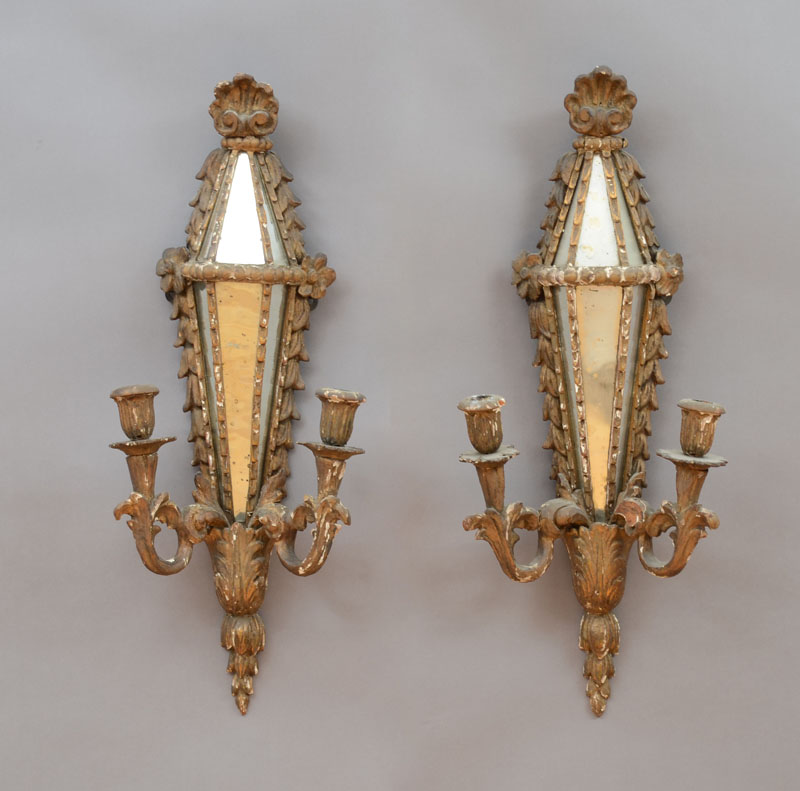 Appraisal: PAIR OF ITALIAN MIRROR-GLASS MOUNTED CARVED GILTWOOD TWO-LIGHT SCONCES Each