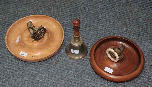 Appraisal: TWO BRASS SHIPS WHEEL NUTCRACKERS mounted on circular wooden bowls