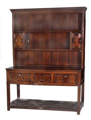 Appraisal: A CAROLEAN STYLE OAK DRESSER having a raised back with