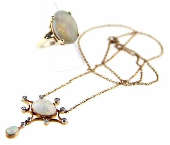 Appraisal: Cabochon opal and gold pendent necklace and ring circa fire