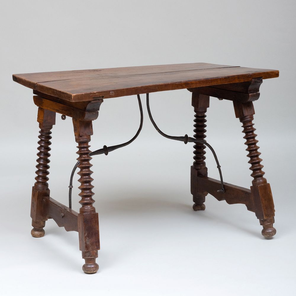 Appraisal: Spanish Walnut And Iron Center Table The top and bun