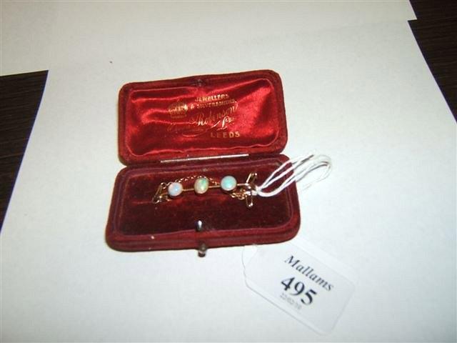 Appraisal: A three stone opal bar brooch in a ct setting