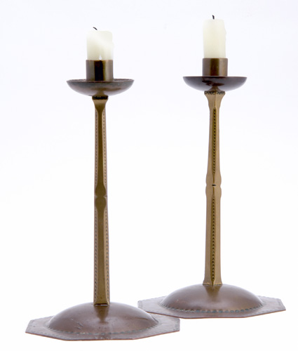 Appraisal: ERNEST GIMSON English Pair of brass candlesticks with faceted base