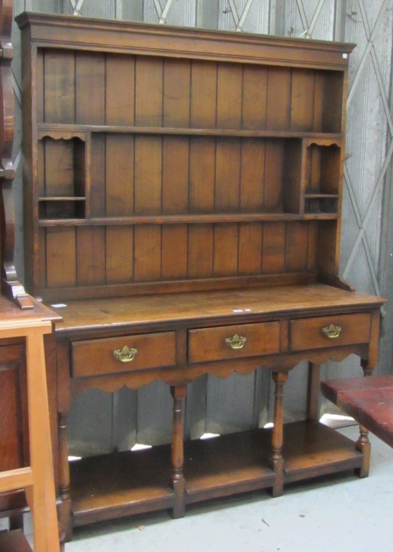 Appraisal: A th century style oak dresser the enclosed two tier