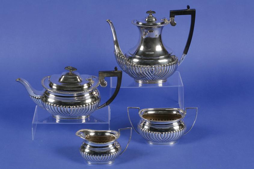 Appraisal: AN EDWARDIAN THREE PIECE TEASET of bellied oval form with