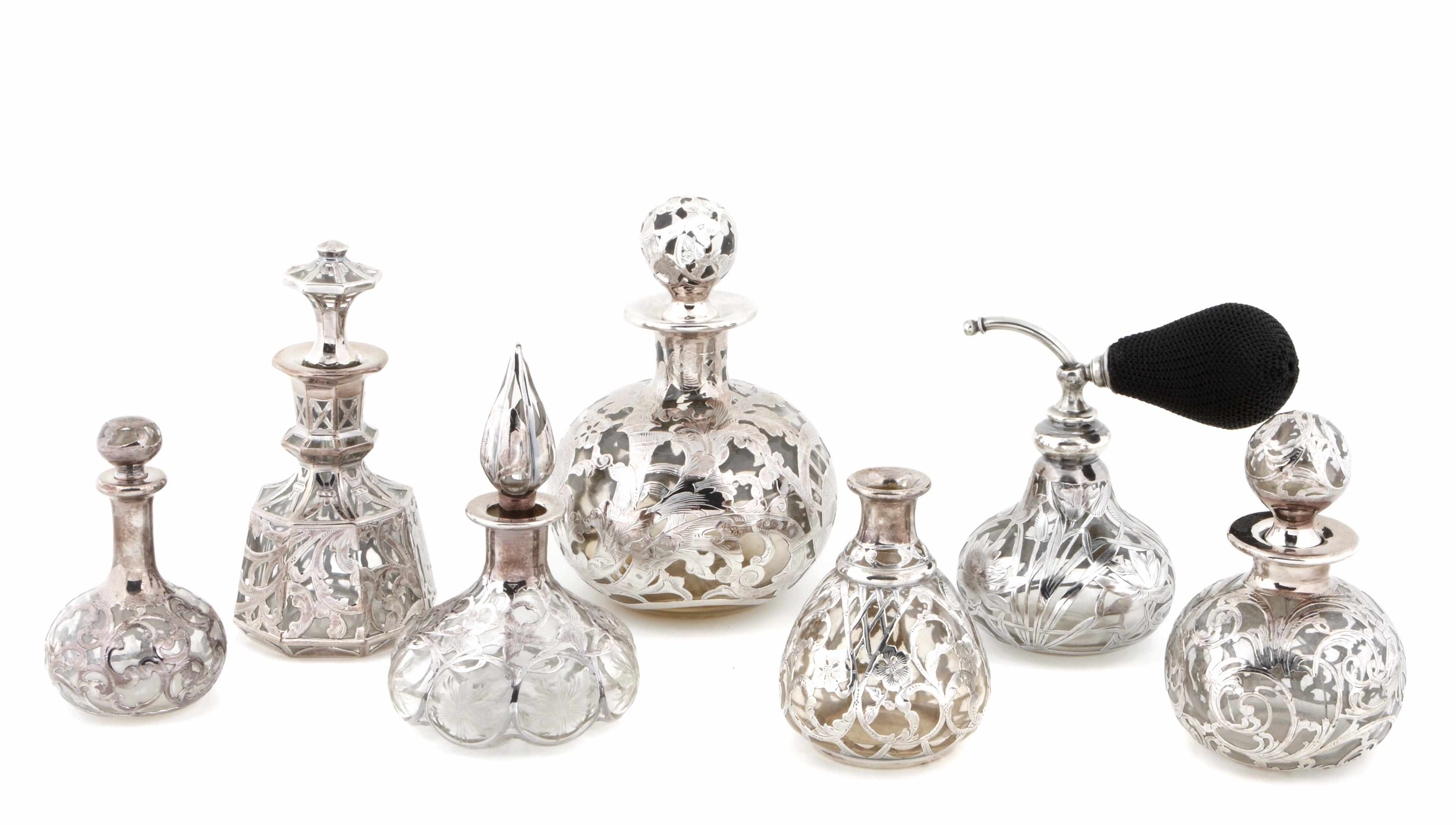 Appraisal: A group of fourteen silver overlay colored glass perfume bottles