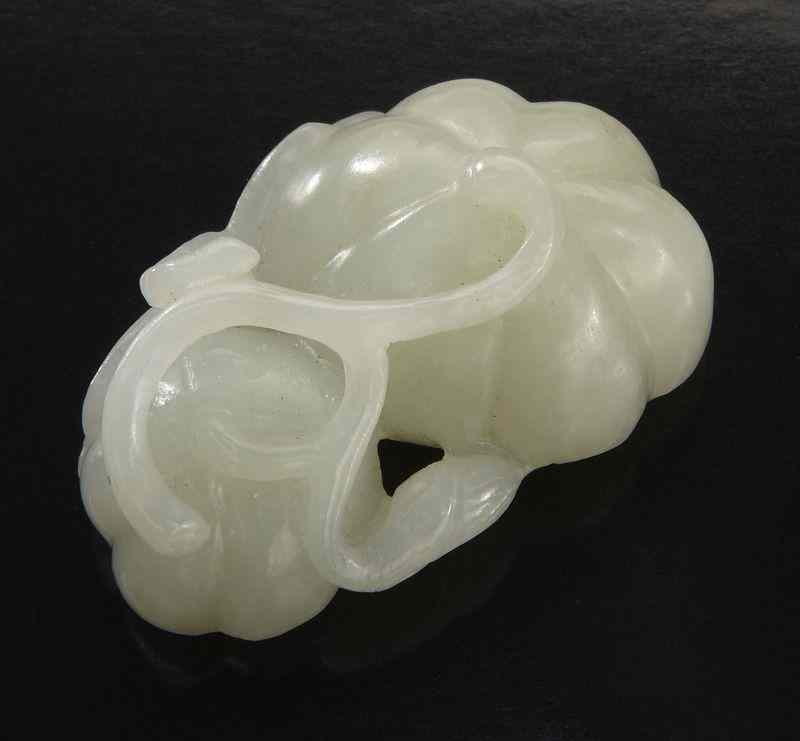 Appraisal: Chinese carved jade lotus seed with a dragonfly ''H x