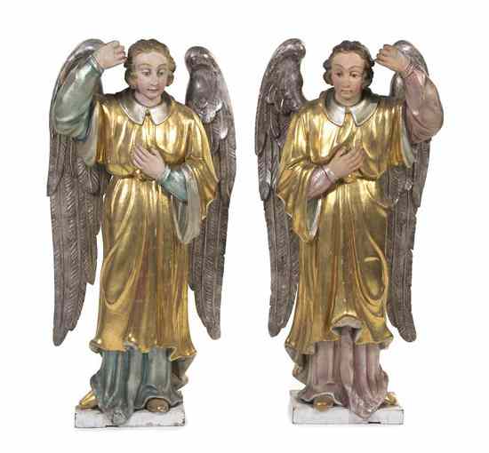 Appraisal: A Pair of Carved and Gilt Models of Angels depicting