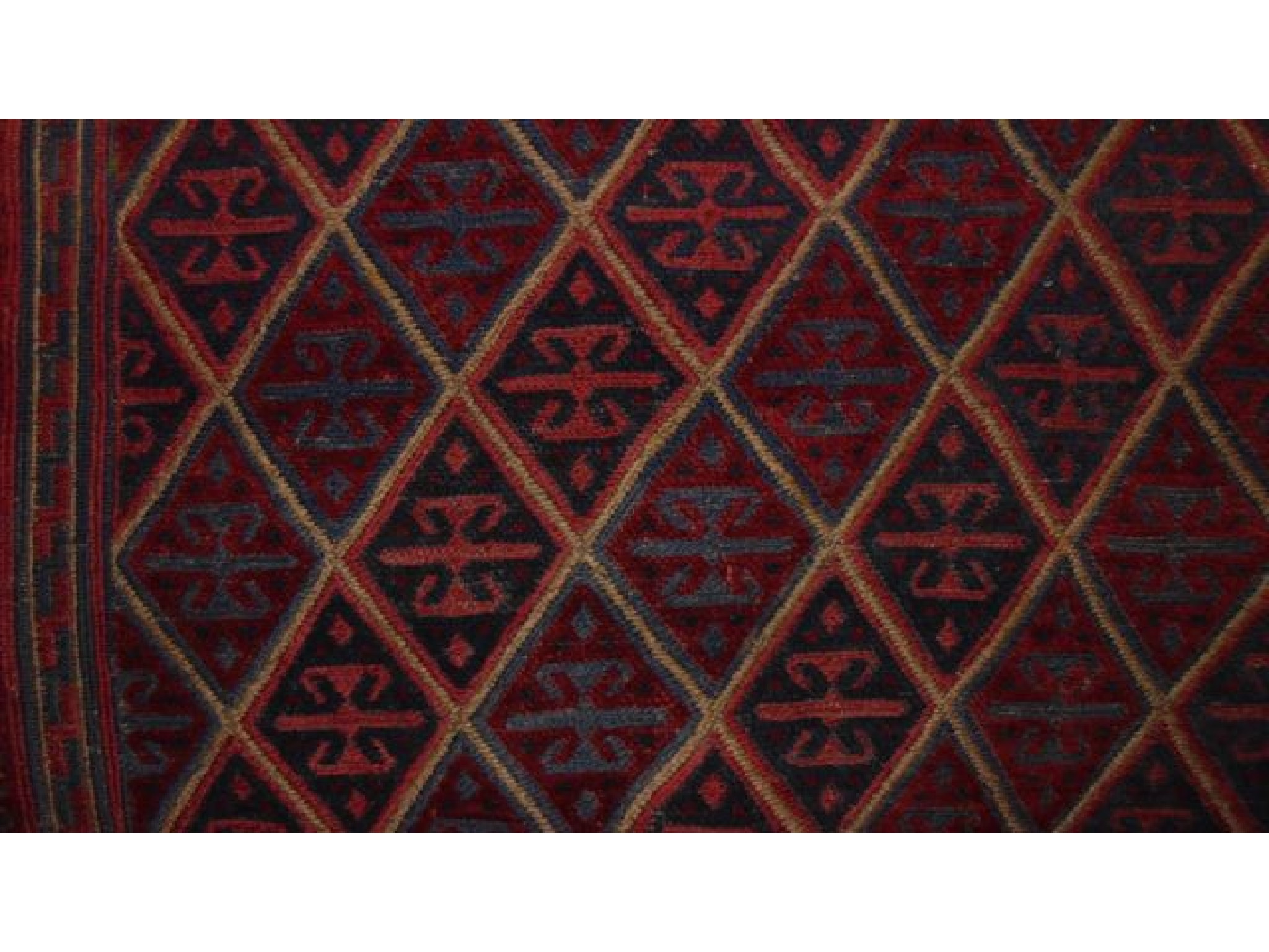 Appraisal: An eastern wool rug principally in a red and blue