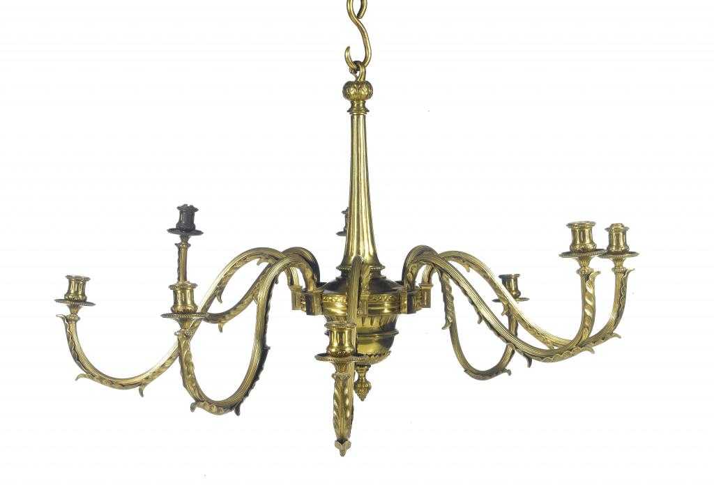 Appraisal: A BRASS EIGHT LIGHT CHANDELIER with leaf clad reeded scrolling