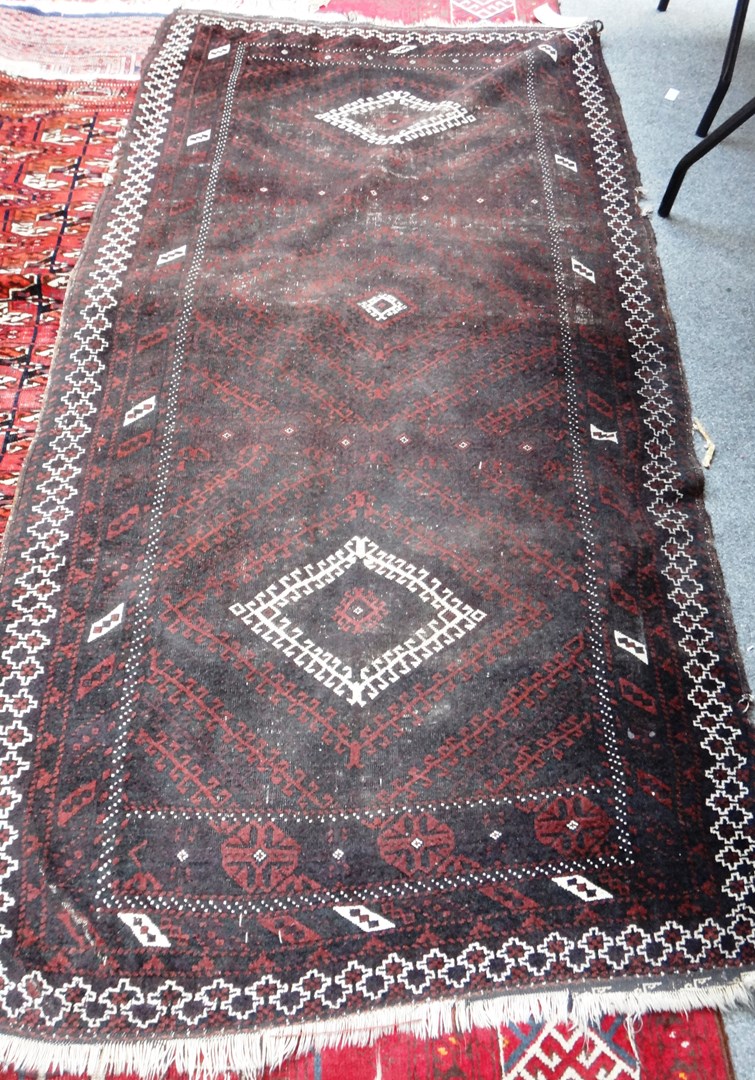 Appraisal: A Baluchistan rug the black field with three concentric hooked