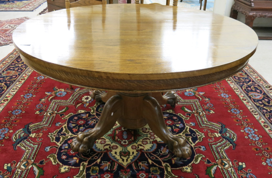 Appraisal: ROUND OAK DINING TABLE WITH TWO LEAVES American early th