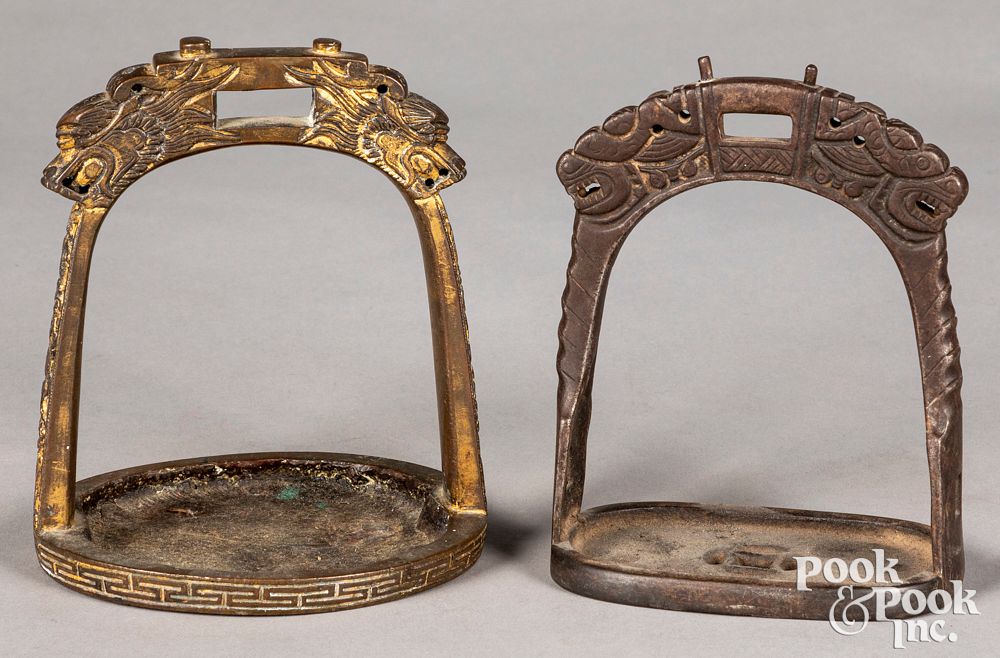 Appraisal: Two Chinese bronze stirrups Two Chinese bronze stirrups one th