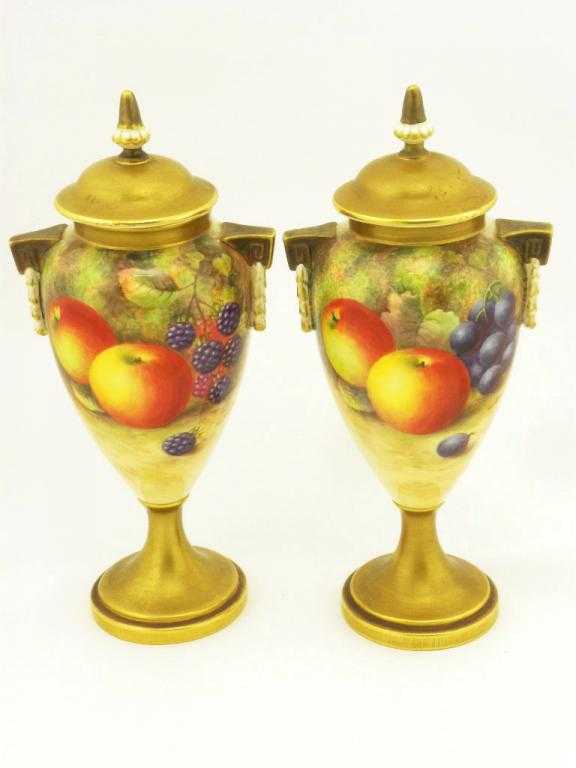 Appraisal: A PAIR OF ROYAL WORCESTER VASES AND COVERS of slender