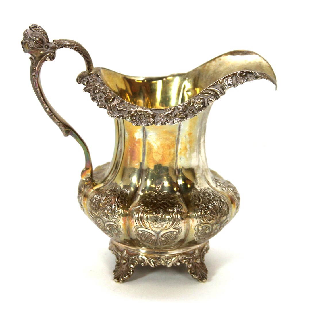 Appraisal: A silver milk jug of fluted baluster form with floral