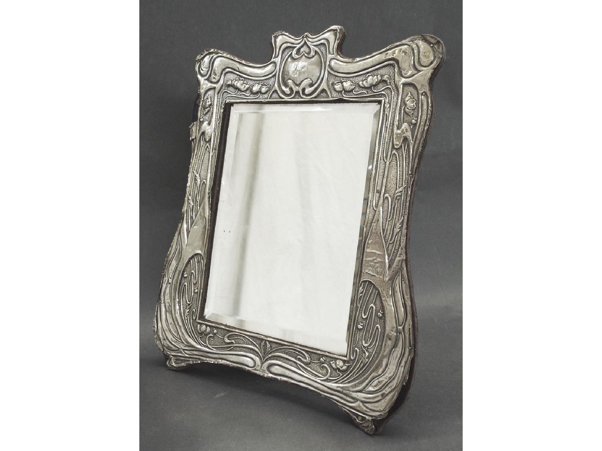 Appraisal: Art Nouveau embossed white metal mounted easel mirror with bevelled