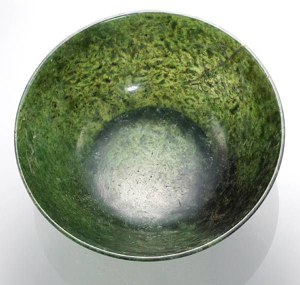 Appraisal: A 'spinach' jade bowl with prunus branch decoration th Century